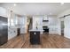 Modern kitchen with white cabinets, stainless steel appliances, dark island, hardwood floors, and adjacent dining area at 3417 Aspen Rd, Rocky Mount, NC 27804