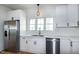 Kitchen area featuring stainless steel appliances, white cabinetry, light countertops, and hardwood floors at 3417 Aspen Rd, Rocky Mount, NC 27804
