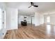 Spacious living room with ceiling fan, access to the kitchen, hardwood floors, and natural light from windows and French doors at 3417 Aspen Rd, Rocky Mount, NC 27804