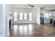 Spacious living room featuring hardwood floors, a fireplace, and stainless steel appliances in the kitchen at 3417 Aspen Rd, Rocky Mount, NC 27804