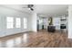 Bright living space with hardwood floors, ceiling fan, and open access to a modern kitchen with white cabinets at 3417 Aspen Rd, Rocky Mount, NC 27804