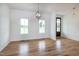 Bright living room with beautiful hardwood floors, elegant lighting, and large windows at 3417 Aspen Rd, Rocky Mount, NC 27804
