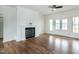 Bright living room with a fireplace and access to a porch via glass paneled doors at 3417 Aspen Rd, Rocky Mount, NC 27804
