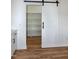 Spacious pantry with custom shelving and stylish sliding barn door for convenient storage at 3417 Aspen Rd, Rocky Mount, NC 27804