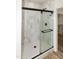 Beautifully tiled shower with seamless glass door and matte black hardware at 3417 Aspen Rd, Rocky Mount, NC 27804