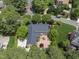 Aerial view of a beautiful home with a manicured lawn, patio, and mature trees at 4109 City Of Oaks Wynd, Raleigh, NC 27612