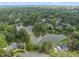 Aerial view showcasing a community with multiple ponds, lush trees, and upscale homes at 4109 City Of Oaks Wynd, Raleigh, NC 27612