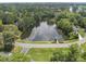 Aerial view of a community lake with a fountain in the center and a quaint gazebo on the side at 4109 City Of Oaks Wynd, Raleigh, NC 27612