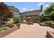 Rear brick patio with exterior views of the house, and surrounding greenery at 4109 City Of Oaks Wynd, Raleigh, NC 27612