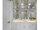 Bathroom vanity featuring a large mirror, white cabinets and stone countertops, and gold fixtures at 4109 City Of Oaks Wynd, Raleigh, NC 27612