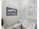 Charming powder room features stylish fixtures, vanity mirror, and decorative accents at 4109 City Of Oaks Wynd, Raleigh, NC 27612