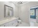 Bathroom with vanity, white cabinets, stone countertops, decorative mirror, and tile flooring at 4109 City Of Oaks Wynd, Raleigh, NC 27612