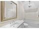 All white bathroom features a marble countertop, large mirror, and a combined shower and tub at 4109 City Of Oaks Wynd, Raleigh, NC 27612