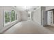 Bedroom features a chandelier, neutral carpet and walls, and large, arched windows to let in natural light at 4109 City Of Oaks Wynd, Raleigh, NC 27612