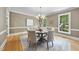 Charming dining room featuring hardwood floors, ample natural light, and a stylish chandelier at 4109 City Of Oaks Wynd, Raleigh, NC 27612