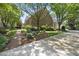 Brick home showcasing manicured lawn, brick walkway, and mature landscaping with a view of the driveway at 4109 City Of Oaks Wynd, Raleigh, NC 27612