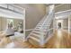 Inviting foyer with hardwood floors, staircase, and views into the adjacent living room at 4109 City Of Oaks Wynd, Raleigh, NC 27612
