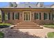 Welcoming brick home entrance featuring a classic door, multiple dormers, and symmetrical design at 4109 City Of Oaks Wynd, Raleigh, NC 27612
