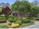 Charming brick home with lush landscaping, mature trees, and a well-maintained front yard at 4109 City Of Oaks Wynd, Raleigh, NC 27612