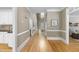 Bright hallway boasting hardwood floors and classic trimwork, seamlessly connecting the living spaces at 4109 City Of Oaks Wynd, Raleigh, NC 27612