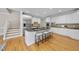 Modern kitchen features a large island with seating and stainless steel refrigerator at 4109 City Of Oaks Wynd, Raleigh, NC 27612