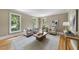Cozy living room with large windows and hardwood floors, perfect for relaxing and entertaining guests at 4109 City Of Oaks Wynd, Raleigh, NC 27612