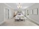 Bright main bedroom offers crown molding, neutral colors, and carpeted flooring at 4109 City Of Oaks Wynd, Raleigh, NC 27612