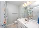 Bright bathroom featuring a white vanity with plenty of space and a shower with colorful shower curtain at 4114 Brenmar Ln, Durham, NC 27713