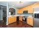 View of the kitchen with stainless steel appliances, wood cabinets and granite countertops at 4114 Brenmar Ln, Durham, NC 27713