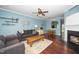 Bright living room with hardwood floors, ceiling fan, and cozy seating arrangement at 4114 Brenmar Ln, Durham, NC 27713