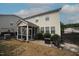 Spacious backyard featuring a screened-in porch, patio area, and mature landscaping at 412 Ashdale Dr, Fuquay Varina, NC 27526