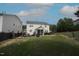 Backyard featuring a screened porch, swing set, and spacious lawn bordered by a dark wood fence at 412 Ashdale Dr, Fuquay Varina, NC 27526