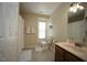 Well-lit bathroom featuring a vanity, toilet, and shower with neutral tile flooring at 412 Ashdale Dr, Fuquay Varina, NC 27526