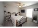 Comfortable bedroom with ceiling fan, large window, television and decorative wrought iron bed frame at 412 Ashdale Dr, Fuquay Varina, NC 27526