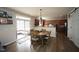 Dining area adjacent to a modern kitchen with hardwood floors and sliding glass doors at 412 Ashdale Dr, Fuquay Varina, NC 27526