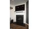 Fireplace with white mantel and large television at 412 Ashdale Dr, Fuquay Varina, NC 27526