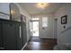 Bright foyer with wood-look floors, decorative wall paneling, and front door at 412 Ashdale Dr, Fuquay Varina, NC 27526