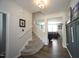 Inviting foyer featuring hardwood floors, stairs, and a view into the living area at 412 Ashdale Dr, Fuquay Varina, NC 27526