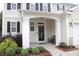 A welcoming front porch with a seating area and neat landscaping at 412 Ashdale Dr, Fuquay Varina, NC 27526