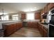 Open kitchen with stainless steel appliances, ample counter space, and wood flooring at 412 Ashdale Dr, Fuquay Varina, NC 27526