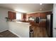 Well-equipped kitchen with stainless steel appliances, wooden cabinets, and modern lighting at 412 Ashdale Dr, Fuquay Varina, NC 27526