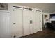 Stylish living area with unique barn doors and hardwood floors, creating a modern look at 412 Ashdale Dr, Fuquay Varina, NC 27526