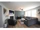 Spacious living room with a fireplace, wall paneling, and modern furniture at 412 Ashdale Dr, Fuquay Varina, NC 27526