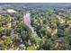 Aerial view of a neighborhood with tree-lined streets and a peaceful lake at 4504 Ryegate Dr, Raleigh, NC 27604