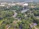 Aerial view of homes nestled amidst lush greenery and a picturesque lake in the background at 4504 Ryegate Dr, Raleigh, NC 27604