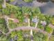 An aerial view looking down at a neighborhood with houses, roads and a winding lake at 4504 Ryegate Dr, Raleigh, NC 27604