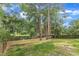 Fenced backyard with mature trees and lush greenery surrounding the property at 4504 Ryegate Dr, Raleigh, NC 27604