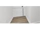 Unfinished basement area featuring exposed concrete walls, wood flooring and an exposed pipe at 4504 Ryegate Dr, Raleigh, NC 27604