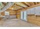 Unfinished basement space featuring plywood walls, concrete floors and a door leading outside at 4504 Ryegate Dr, Raleigh, NC 27604