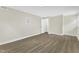 View of bedroom featuring light-colored walls, wood floors, white trim and an open door at 4504 Ryegate Dr, Raleigh, NC 27604